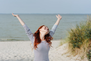 Young woman rejoicing in the warm sunshine