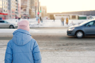 Girl in a knitted hat in winter.