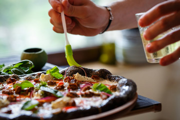 Closeup hand of chef baker making pizza at kitchen.