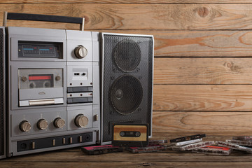 old tape recorder and cassette on  wooden background