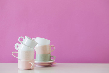 modern cups on white table on background pink wall