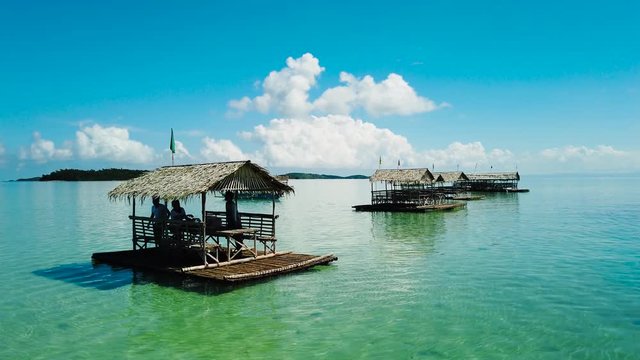 A floating cottages on a Manlawi sandbar in the tourist island of Caramoan in the Philippines. Bamboo bungalows on the water.