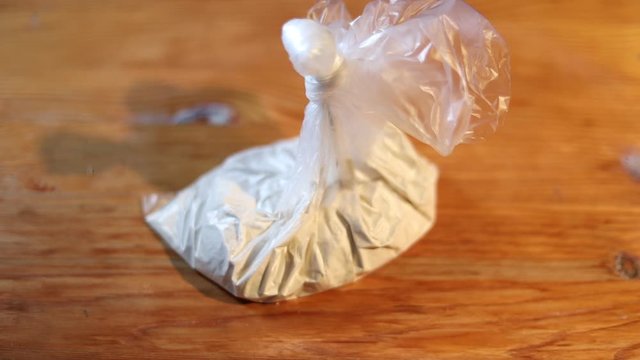 Dropping a bag of cocain on the board