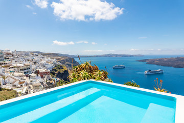 Fototapeta na wymiar Santorini, Greece. Famous view of traditional white architecture Santorini landscape with infinity pool. Summer vacations background. Luxury travel tourism concept. Amazing summer destination