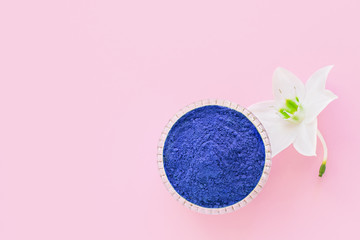 matcha dry blu powder on a pink background for making Japanese natural tea.