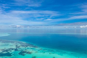 Tropical islands and atolls in Maldives from aerial view. Famous travel destination and luxury vacation or summer holiday concept. Aerial landscape of blue sea and resorts, hotels. Beautiful nature