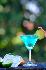blue cocktail with lime and mint