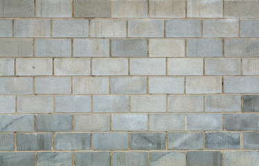 Gray brick concrete wall background. Texture of concrete bricks or blocks for construction. Stone and industrial patterns