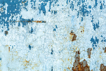 Old peeling paint texture on a wooden wall background. Pattern and texture of old dried paint and stucco on a rough surface