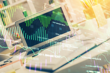 Financial chart drawing and table with computer on background. Double exposure. Concept of international markets.
