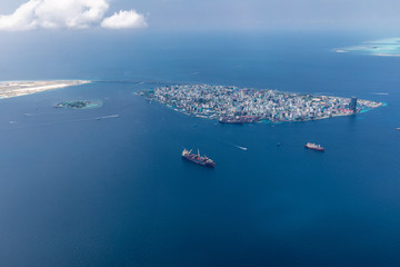 Male island, capital of Maldives with boats and ships. Amazing aerial landscape, exotic travel destination © icemanphotos