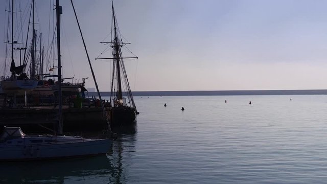 Yacht leaves marina with lighthouse in distance - Puerto Sherry (Cadiz) with light house in distance 