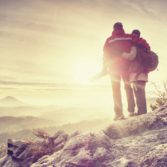 Pair of travelers on peak trail. Two photographers, a man and woman