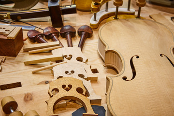 Luthier workshop with violin parts and tools. Traditional craftmanship.
