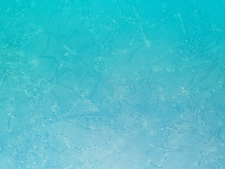 Natural abstract pattern on a frozen puddle. Nature background. Gradient color