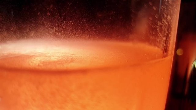 Orange Effervescent Vitamin C Flu Tablet Dissolving In A Glass Of Water, Sparkling And Fizzing Bubbles