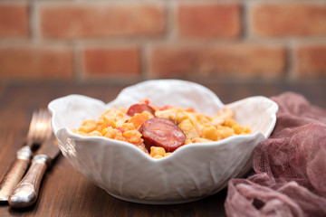 chick pea with cabbage, carrot and smoked sausages in beautiful bowl
