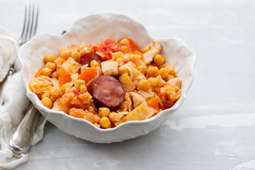 chick pea with cabbage, carrot and smoked sausages in beautiful bowl
