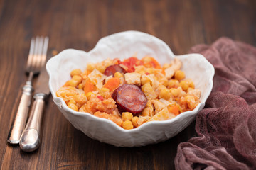 chick pea with cabbage, carrot and smoked sausages in beautiful bowl
