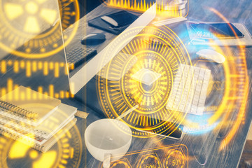 Computer on desktop in office with technology theme hologram. Multi exposure. Tech concept.