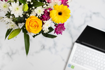 flowers and notebook on light gray background