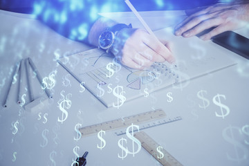 Double exposure of man's hands writing notes of stock market with forex chart.