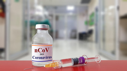 Vaccine and syringe injection with blurred hospital background.It use to prevent and treatment for new corona virus infection(novel coronavirus or nCoV 2019 from Wuhan).Infectious disease concept