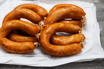 portuguese smoked sausages alheira on paper wooden background