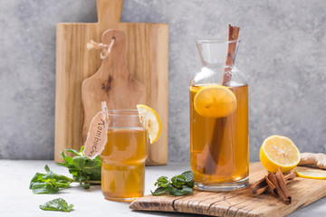Kombucha or cider fermented drink. Cold tea beverage with beneficial bacteria on concrete  background side view with copyspace. For healthy nutrition.