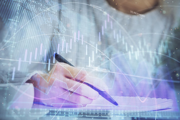 Forex chart displayed on woman's hand taking notes background. Concept of research. Multi exposure