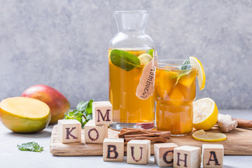 Kombucha or cider fermented drink. Cold tea beverage with beneficial bacteria, cinnamon, lemon on...