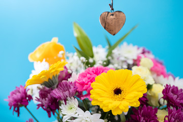 beautiful flowers with heart on blue background