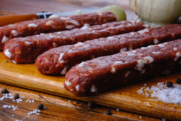 cooking pork sausages composition on a wooden background