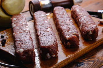 cooking pork sausages composition on a wooden background