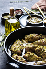 close-up of juicy Pesto Chicken in a black dish