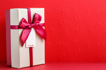cardboard biodegradable gift box with bows on red background