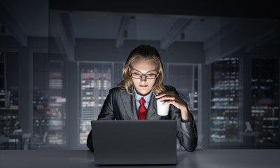 Businesswoman at desk looking at laptop