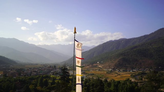 Temple Dzong and religious prayer flags in valley, Bhutan