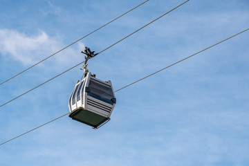 Fototapeta na wymiar View of cableway gondola cable car on blue sky background