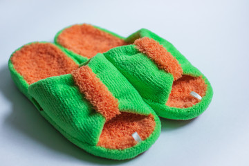 Bright fluffy slippers isolated on a white background. Home women's or children's clothing and shoes. The concept of home warmth and comfort. Selective focus. place for text
