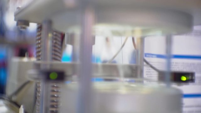modern production.plastic processing and production.round plastic granules are poured into the hopper of the production equipment.close-up.shallow depth of field.abstract technology background