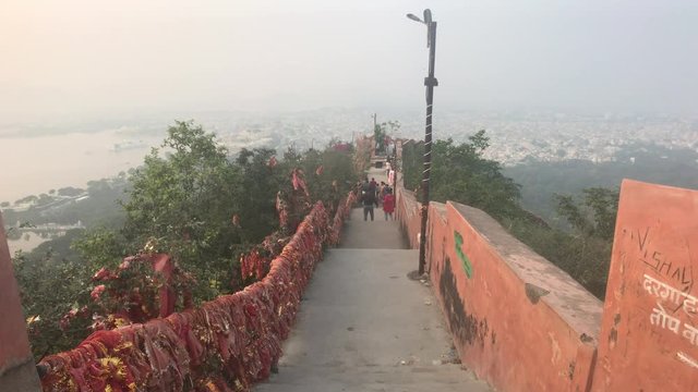 Udaipur, India - November 12, 2019: Mansapurna Karni Mata Ropeway tourists walk on top of the mountain 4K