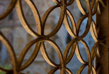 wrought iron fence painted white. Rusty.Decorative circular elements