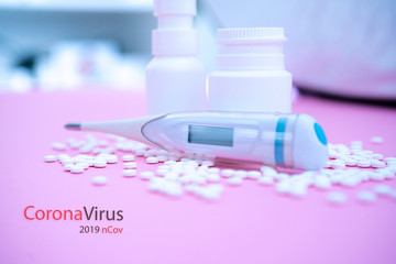 Concept novel coronavirus 2019-nCoV. Chinese coronavirus outbreak. MERS-Cov middle East respiratory syndrome coronavirus.Pills and thermometer with CORONAVIRUS text. Virus Pandemic Protection Concept