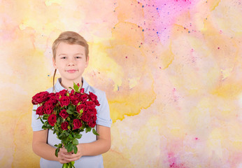 boy with a bouquet of red roses, portrait of a cute boy in a blue polo on colorful background, greeting and gift for Mother's day or Valentine's day