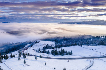 Obraz premium Pasul Tihuta, Romania seen from a drone early in a winter morning. 