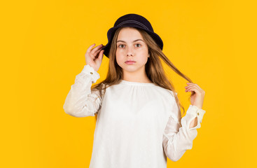 Facial care. retro girl yellow background. pretty little kid in retro hat. vintage fashion look. summer accessory collection. small child long hair. beauty and style. Following her personal style