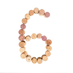 The number 6 is made from wine corks, close-up. Isolated on white background