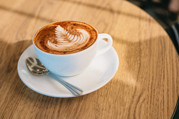 Coffee latte art on wooden table