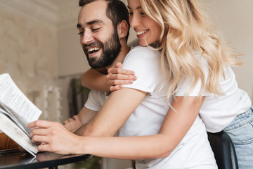 Optimistic loving couple reading book.